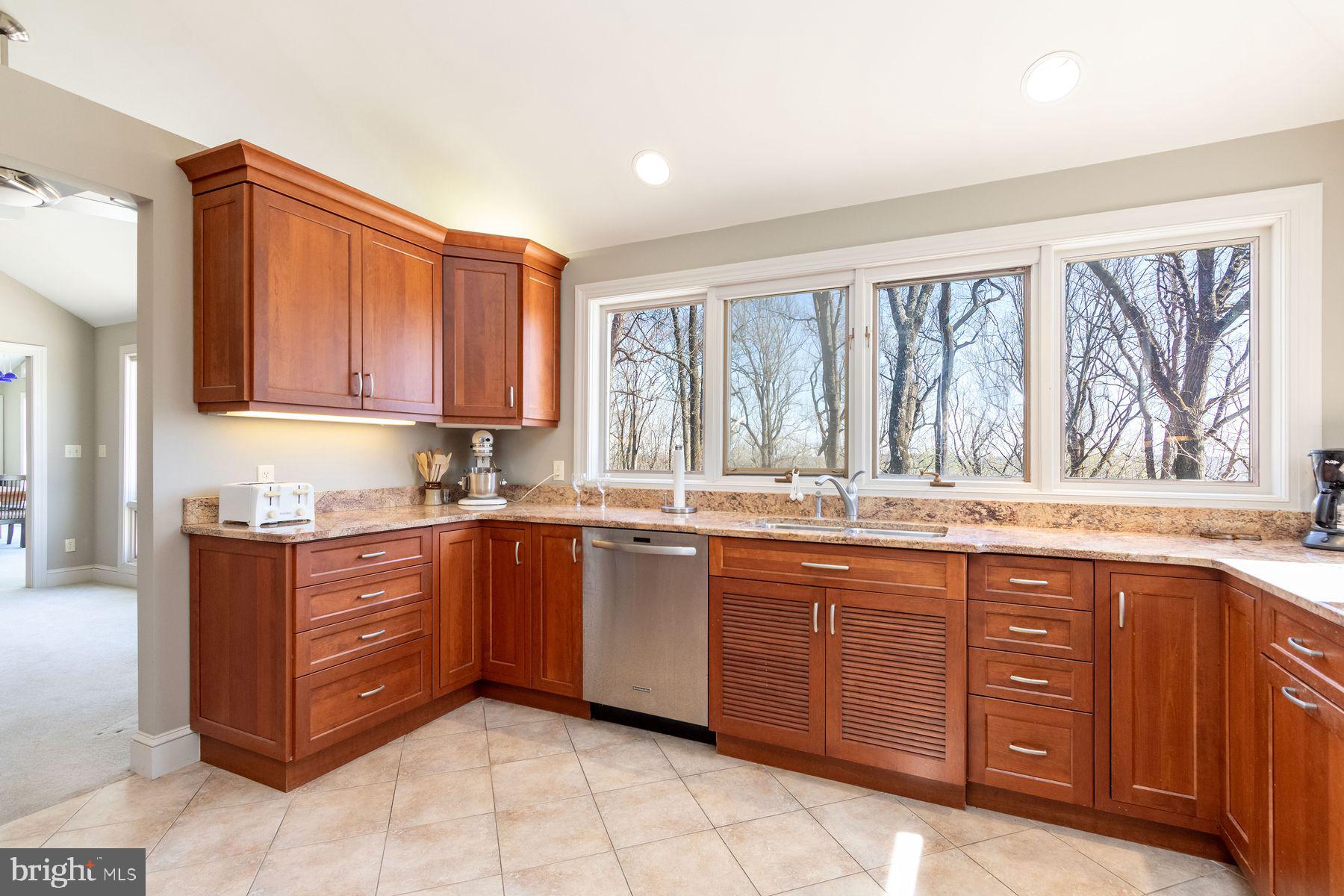 20 Solebury Mountain Road New Hope, PA 18938 - Photo 19 of 43 a large kitchen with kitchen island granite countertop a stove a sink dishwasher and wooden cabinets with wooden floor