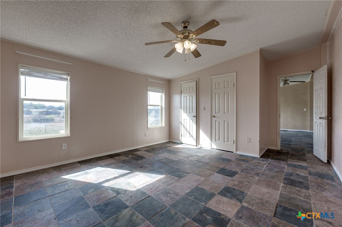809 Crest Court Copperas Cove, TX 76522 - Photo 13 of 22 a view of an empty room with window and chandelier fan