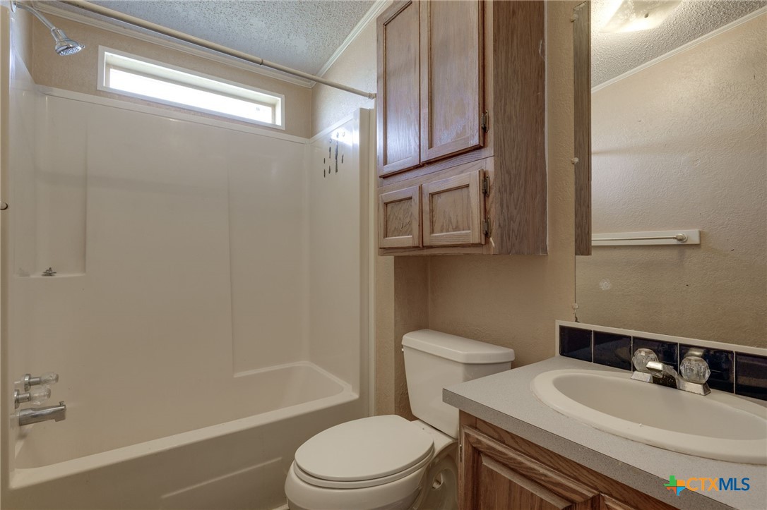 809 Crest Court Copperas Cove, TX 76522 - Photo 18 of 22 a bathroom with a sink a toilet and shower