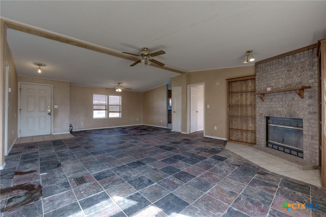 809 Crest Court Copperas Cove, TX 76522 - Photo 7 of 22 a view of empty room with a fireplace and window
