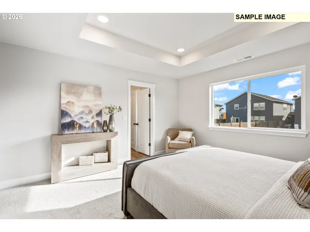 a bedroom with a bed and a large window