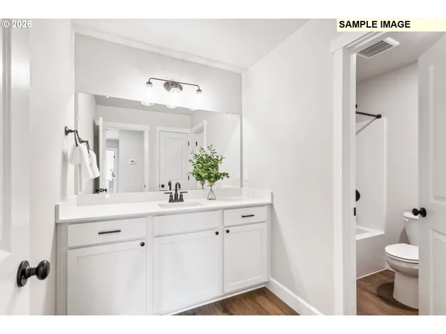 a bathroom with a sink a toilet and a mirror