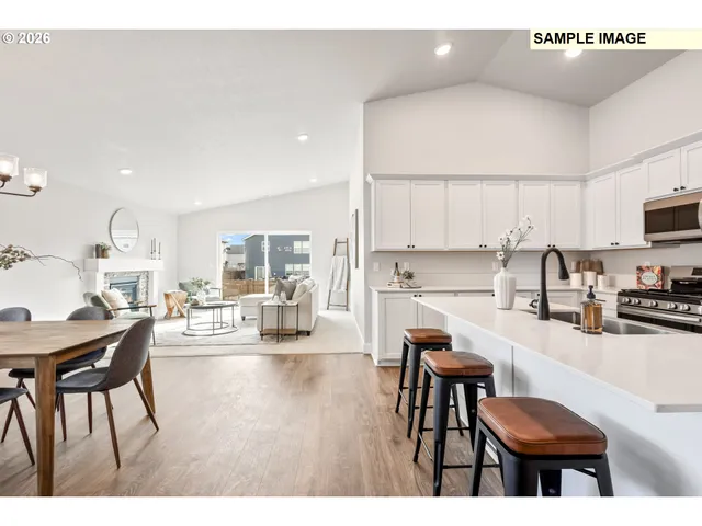a living room with stainless steel appliances kitchen island granite countertop furniture and a view of kitchen