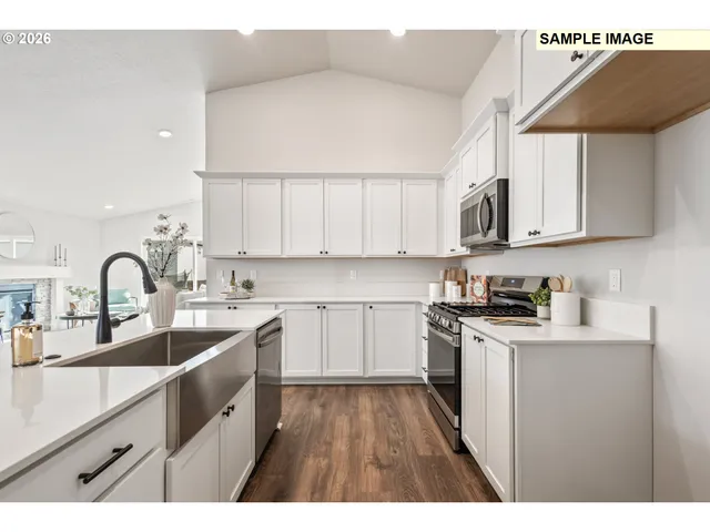 a kitchen with kitchen island granite countertop a sink stainless steel appliances and cabinets