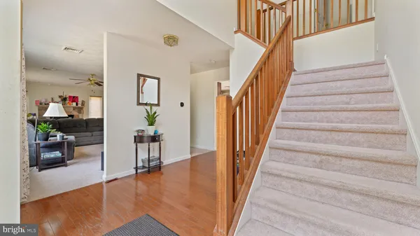 a view of entryway and hall with wooden floor