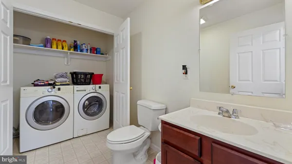 a bathroom with a sink a washer and dryer