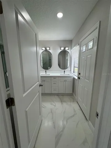 a bathroom with a tub sink and shower
