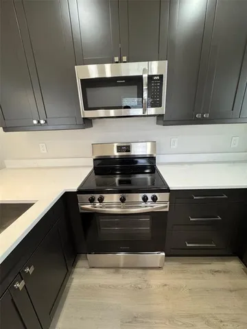 a kitchen with a stove and a microwave