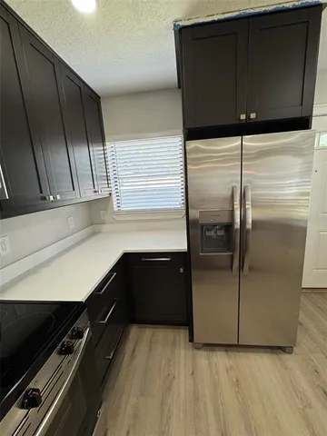 a kitchen with a refrigerator and a sink