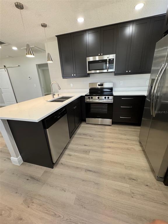 306 Crevasse Street Lakeland, FL 33805 - Photo 8 of 30 a kitchen with stainless steel appliances kitchen island granite countertop a refrigerator and a stove