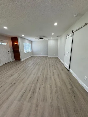 a view of an empty room with a window