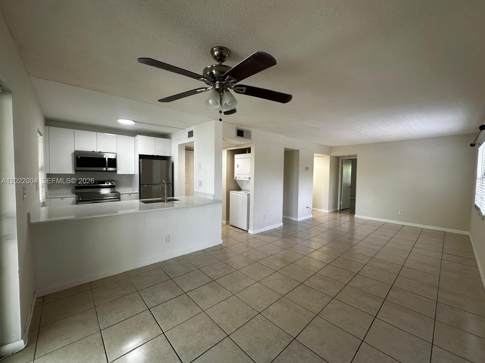 3400 Foxcroft Road, Unit 301 Miramar, FL 33025 - Photo 15 of 72 a view of a kitchen with microwave and cabinets