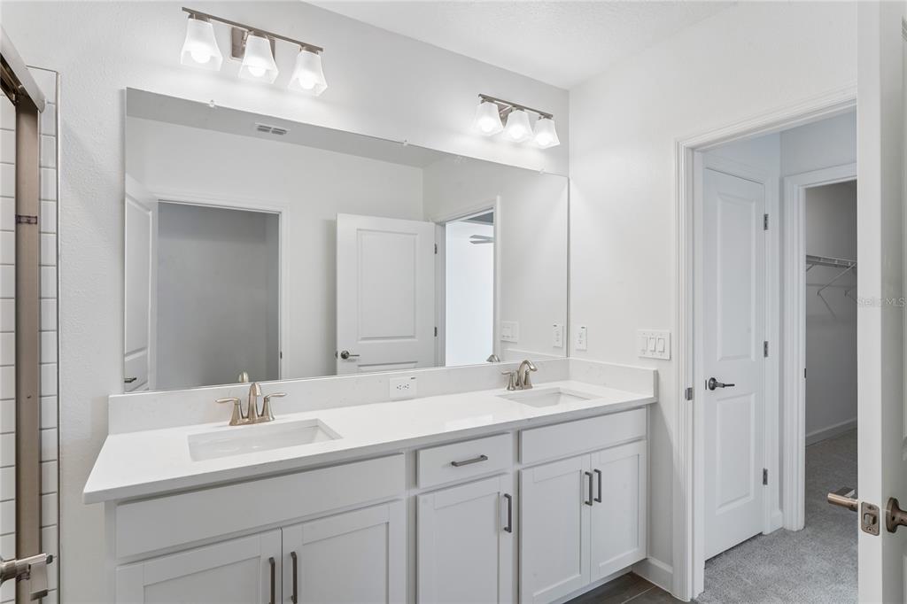 6692 Homebound Way New Port Richey, FL 34653 - Photo 26 of 47 a bathroom with double sink and a mirror