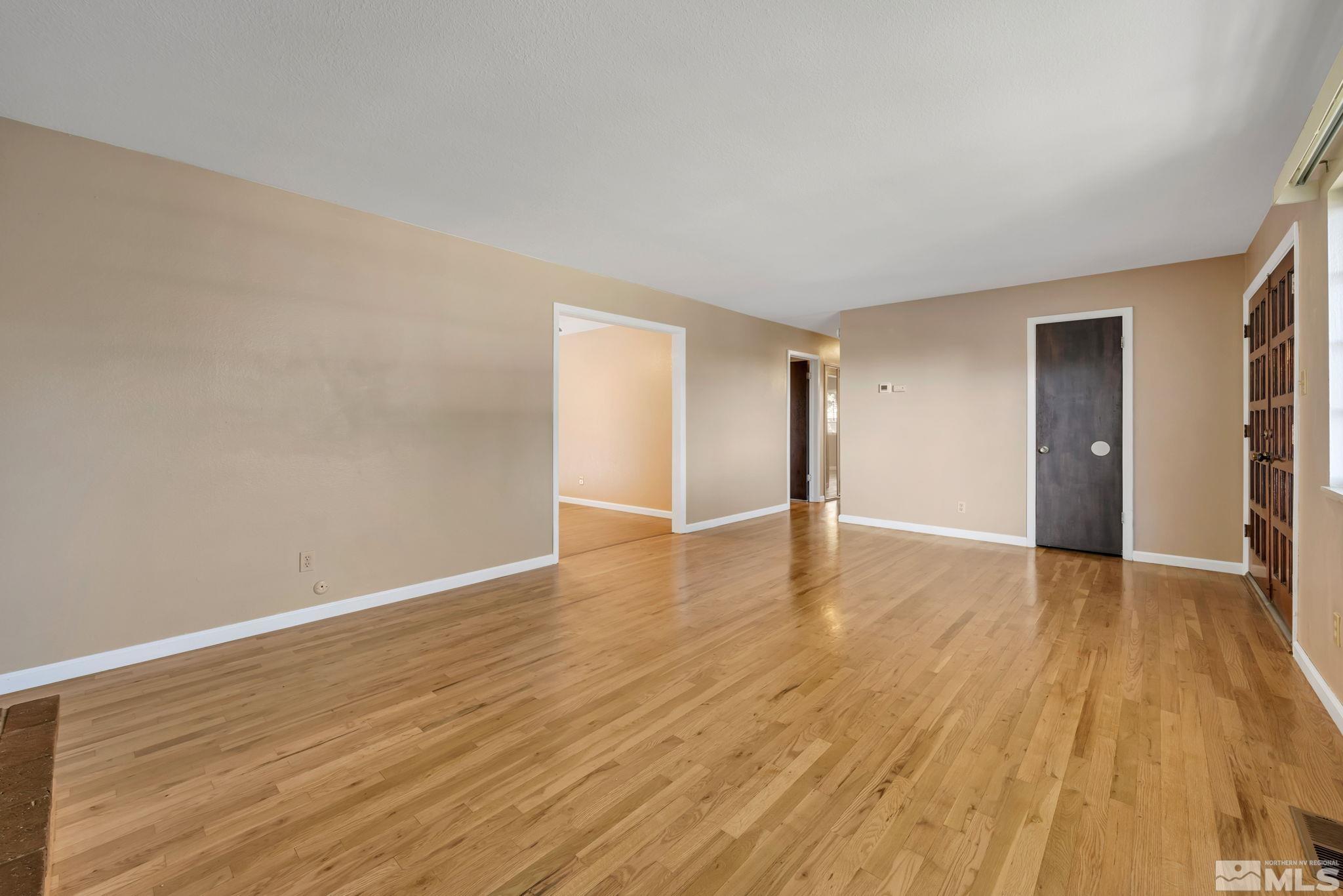 3240 Kings Row Reno, NV 89503 - Photo 13 of 31 a view of an empty room with wooden floor and a window
