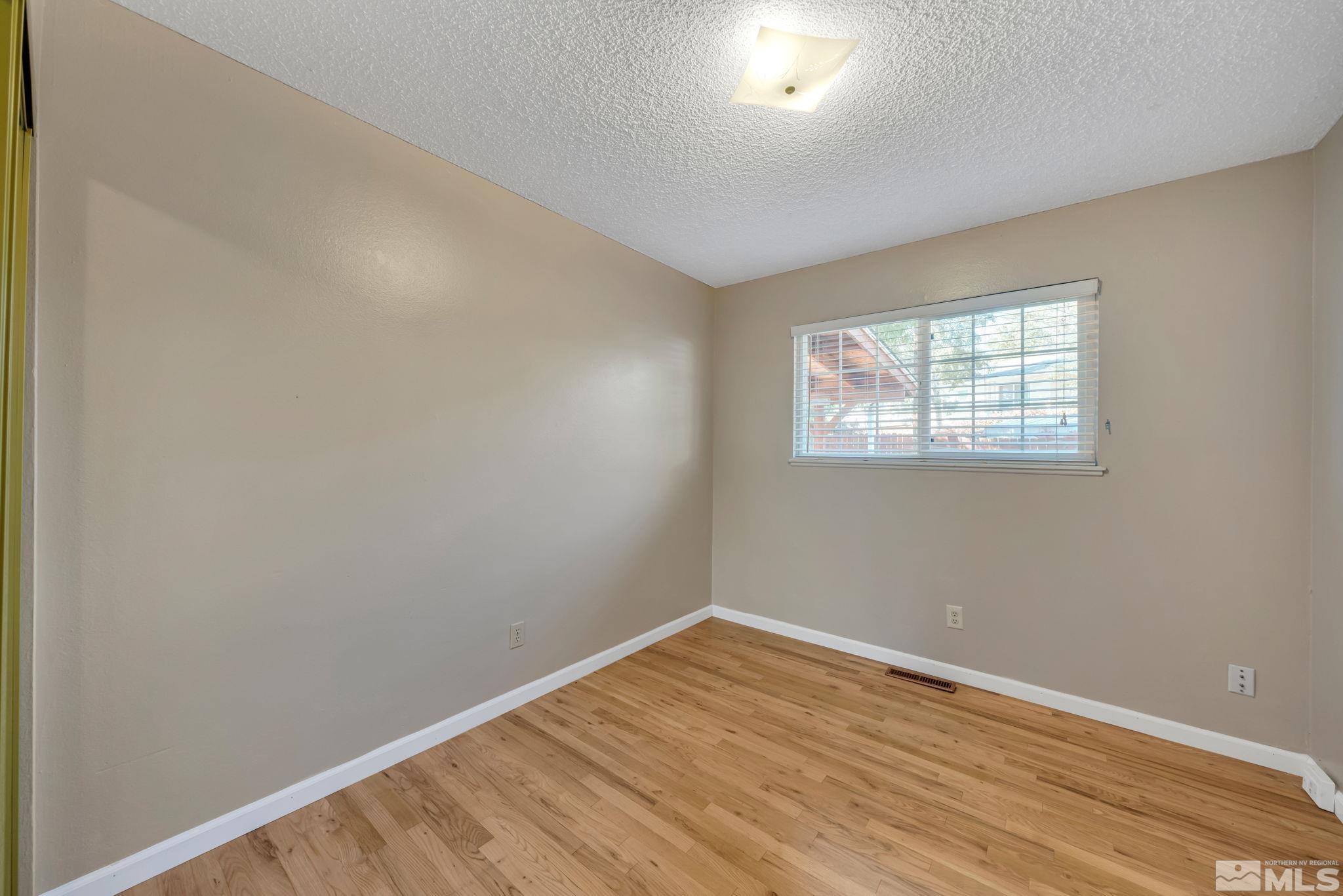 3240 Kings Row Reno, NV 89503 - Photo 20 of 31 an empty room with wooden floor and windows