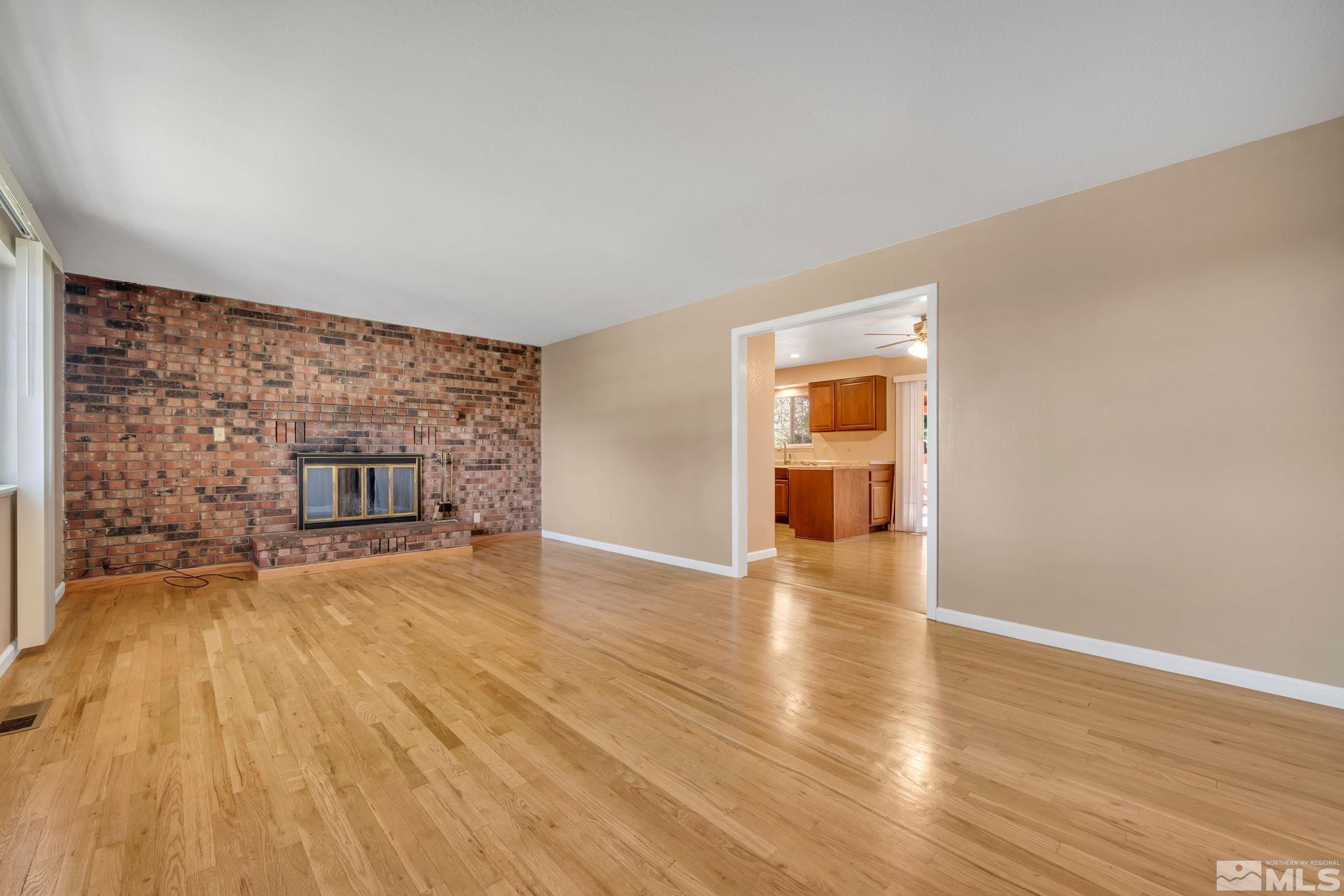 3240 Kings Row Reno, NV 89503 - Photo 4 of 31 a view of empty room with wooden floor and fireplace