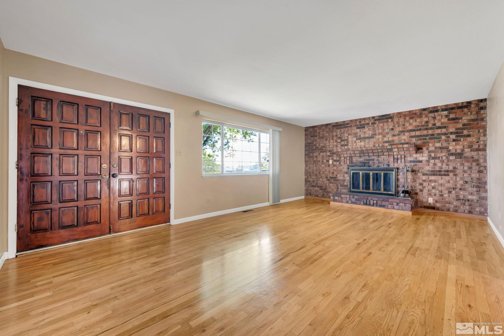 3240 Kings Row Reno, NV 89503 - Photo 5 of 31 a view of an empty room with a window and wooden floor