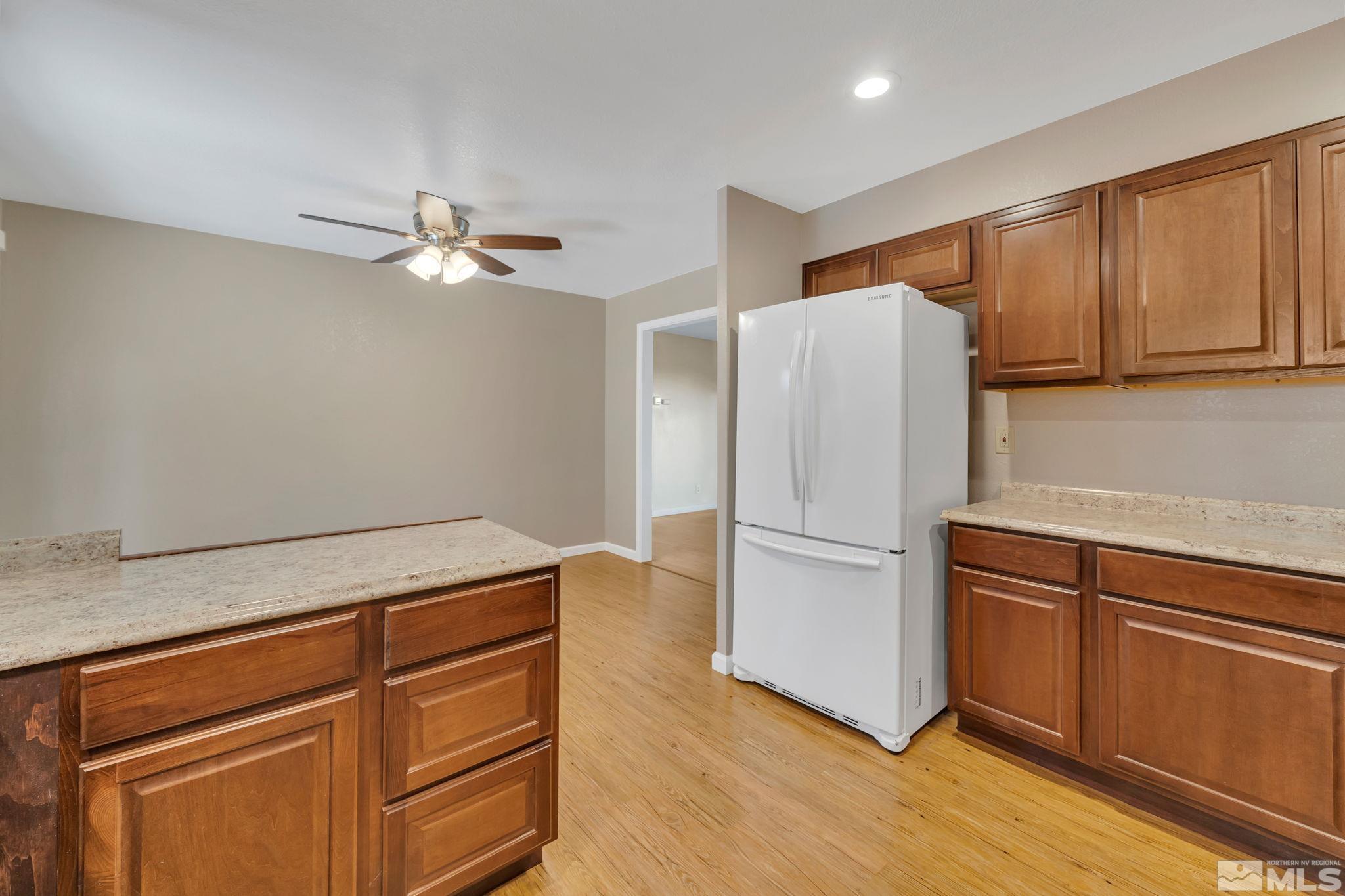 3240 Kings Row Reno, NV 89503 - Photo 9 of 31 a kitchen with granite countertop stainless steel appliances and wooden floor