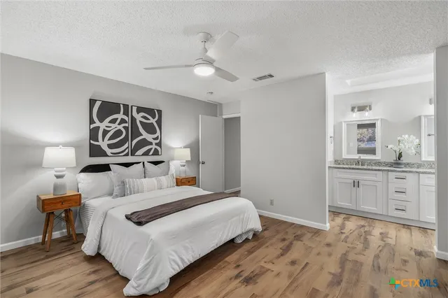 a bedroom with a white bed and dresser