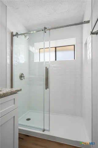 a bathroom with a shower and a tub