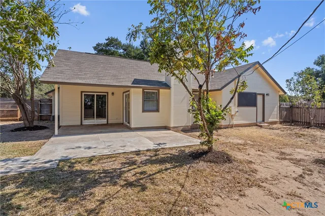 a large tree in front of a house