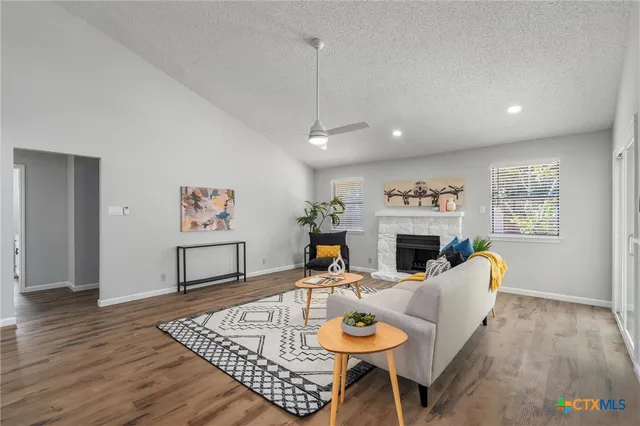 a living room with furniture a fireplace and a table