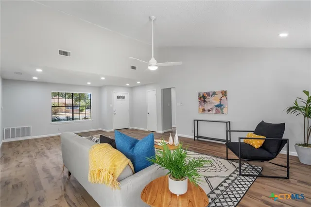 a living room with furniture or couch and a potted plant