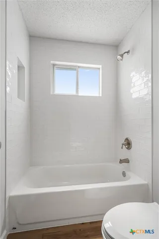 a bathroom with toilet bathtub and shower