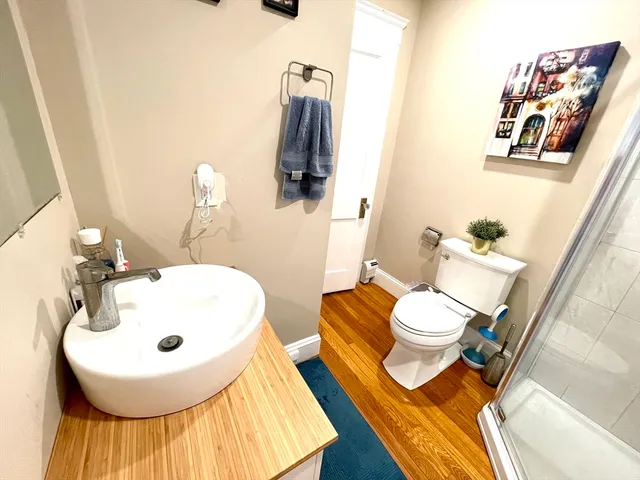a bathroom with a sink and mirror with toilet