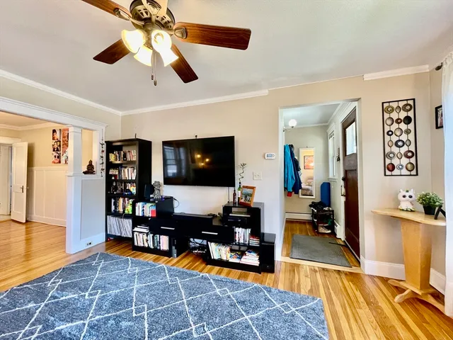 a living room with furniture a rug and a flat screen tv