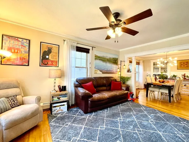 a living room with furniture and a ceiling fan
