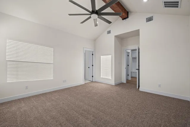 a view of a livingroom with a ceiling fan and window