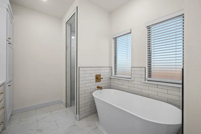 a bathroom with a bathtub and shower