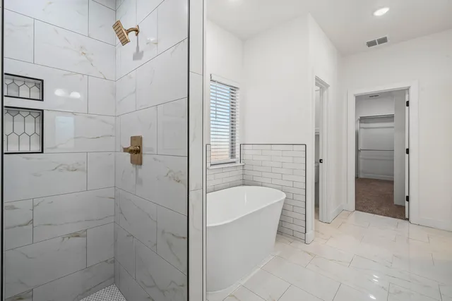 a bathroom with a bathtub and shower