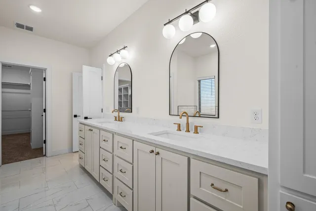 a bathroom with a double vanity sink and a mirror