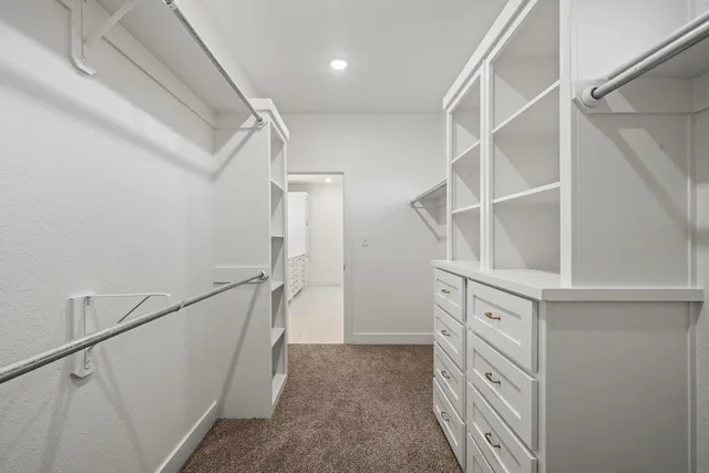 a view of walk in closet with empty racks
