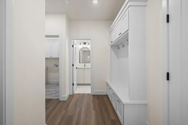 a view of a hallway with wooden floor and staircase