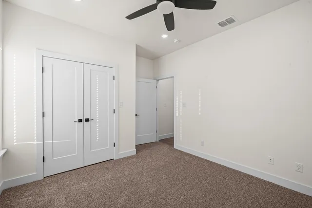 an empty room with ceiling fan