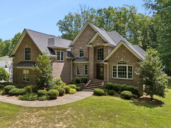 a front view of a house with a yard
