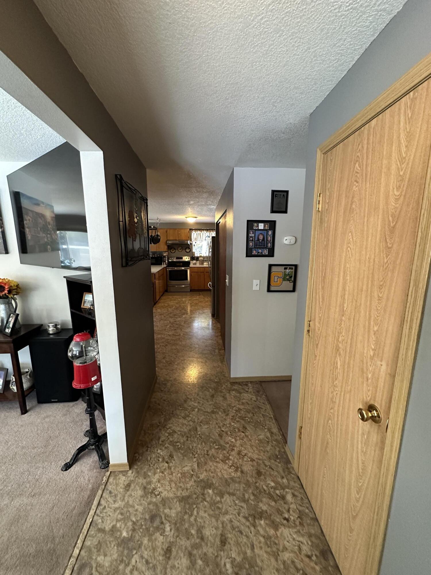 123977 Surveyor Road Crescent Lake, OR 97733 - Photo 9 of 41 a view of a hallway with a couch and a window