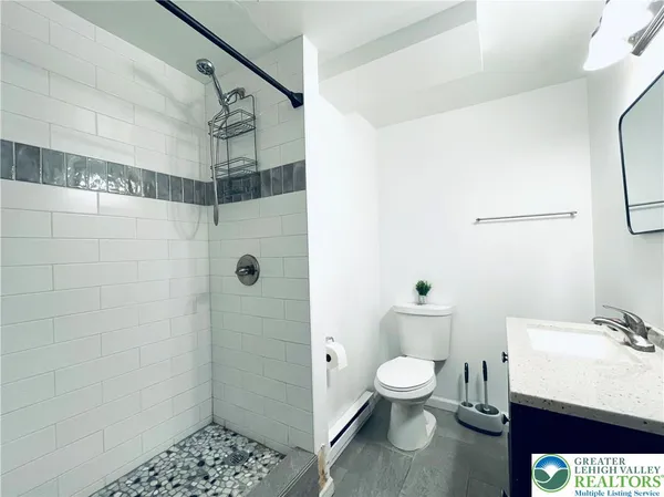 a bathroom with a toilet a sink and shower