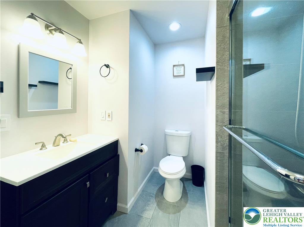 3104 Northgate Road Lake Ariel, PA 18436 - Photo 17 of 36 a bathroom with a sink a toilet and a mirror