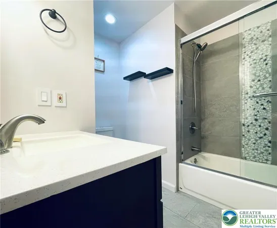 a bathroom with a sink a mirror and a bathtub