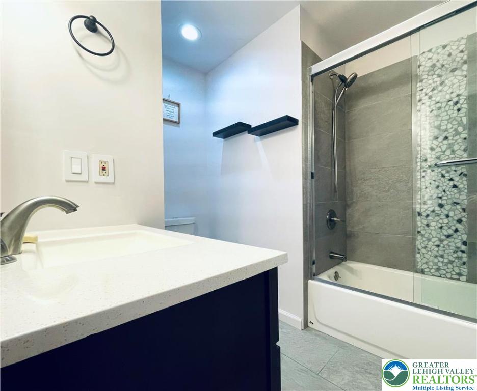 3104 Northgate Road Lake Ariel, PA 18436 - Photo 21 of 36 a bathroom with a sink a mirror and a bathtub