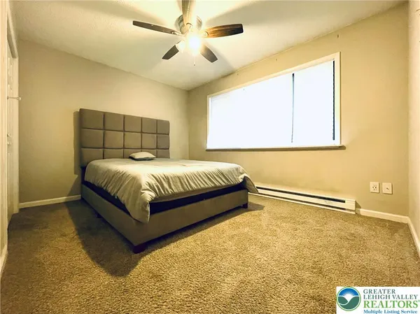 a bedroom with a bed and window