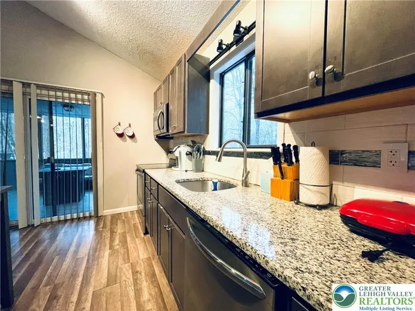 a kitchen with sink and cabinets