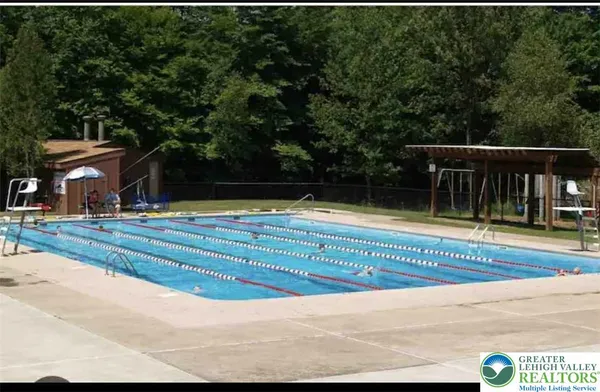 a view of swimming pool with small yard