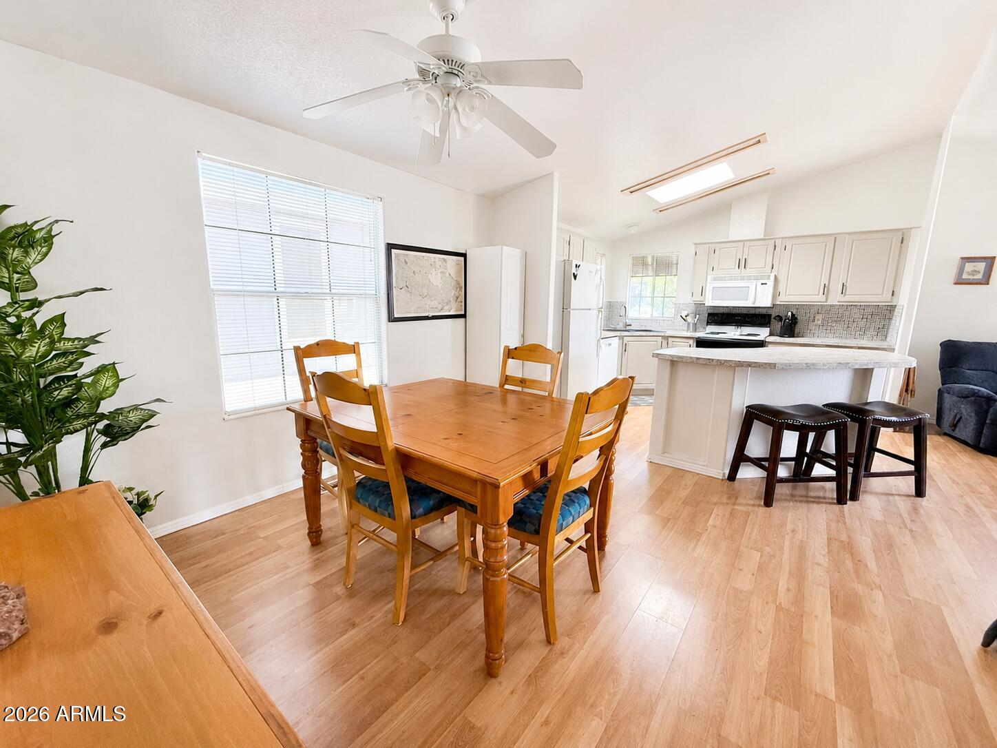 8865 East Baseline Road, Unit 103 Mesa, AZ 85209 - Photo 16 of 47 a view of a dining room with furniture and wooden floor