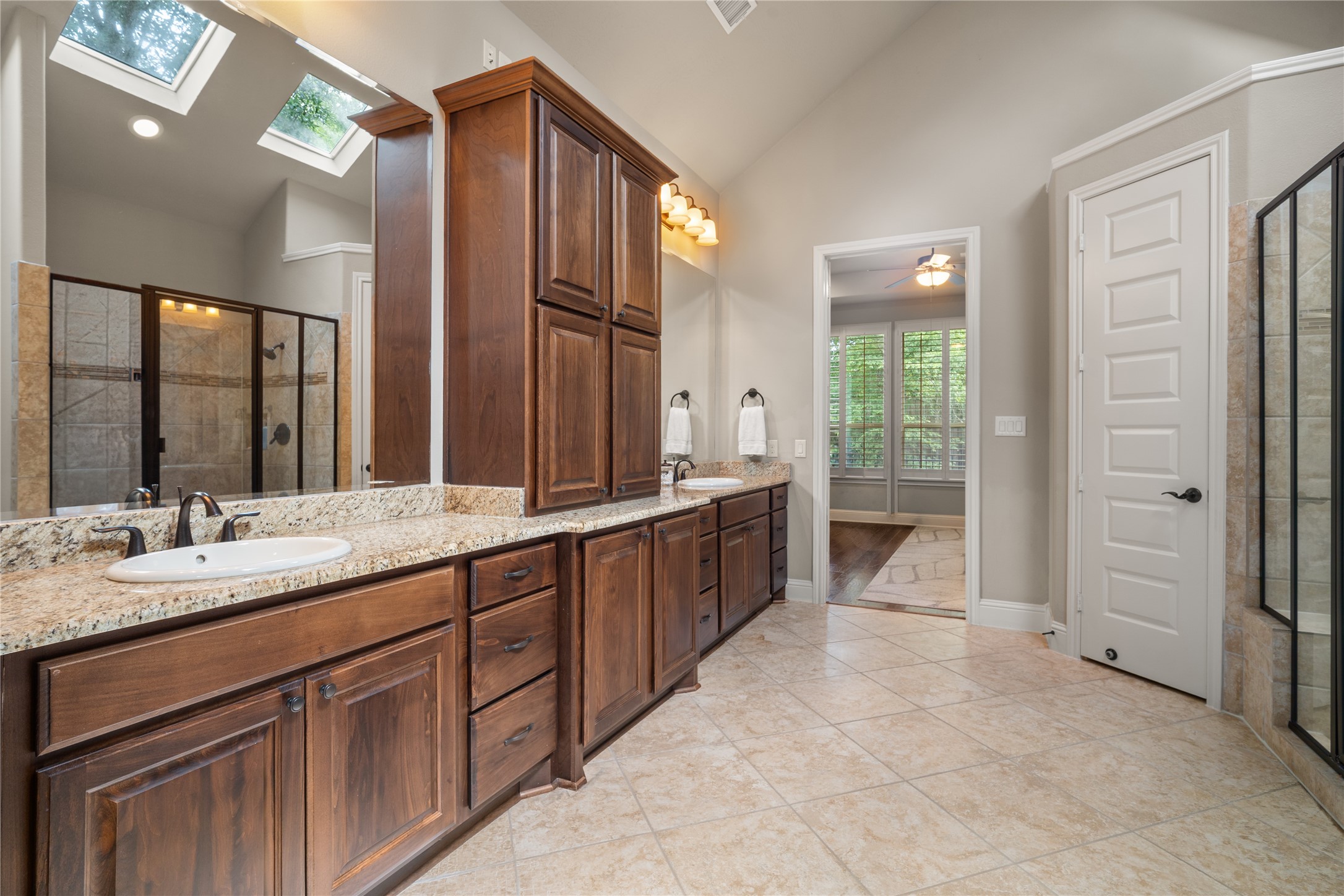 19813 Cullen Ridge Drive Porter, TX 77365 - Photo 24 of 44 This elegant bathroom boasts ample counter space and dual sinks, offering both style and functionality for your daily routine.