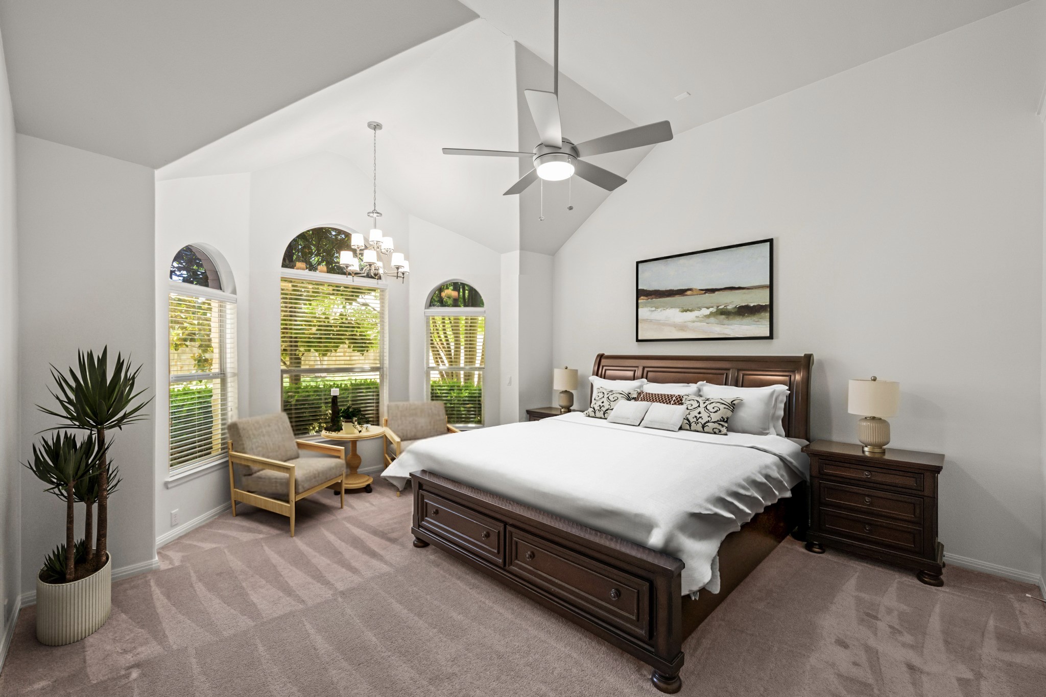1023 Grassy Field Road Austin, TX 78737 - Photo 16 of 40 Vaulted ceiling primary bedroom and seating area with a contemporary ceiling fan and chandelier lighting. Virtual staging.
